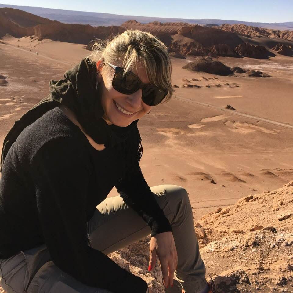 Viajante no Valle de la Luna com formações rochosas ao fundo